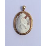 A large oval shell cameo depicting an angel clutch