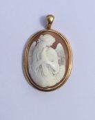 A large oval shell cameo depicting an angel clutch