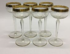 A set of six tall glass and gilded champagne flute
