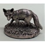 A modern silver model of a fox in standing positio