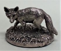 A modern silver model of a fox in standing positio