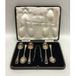 A box containing Edwardian bright cut silver teasp