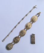 Two silver bracelets together with a silver ingot.