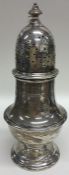 A heavy tall silver caster with lift-off cover. Lo