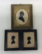 A group of three small framed silhouettes. Est. £1