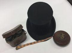 A pair of old field glasses, tape measure and a to