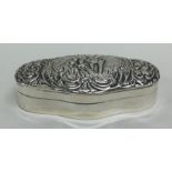 An oval embossed hinged top dressing table box wit