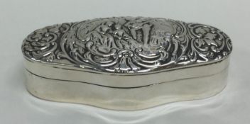 An oval embossed hinged top dressing table box wit