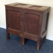 An oak hinged top box on panelled feet. Est. £30 -