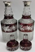A good pair of cranberry glass and silver mounted