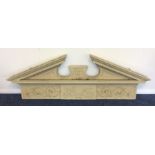 A large painted cornice decorated with scrolls and