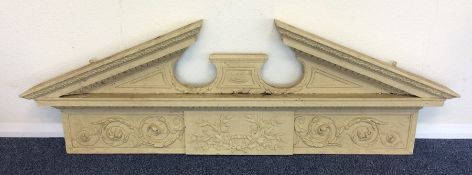 A large painted cornice decorated with scrolls and