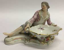 A Meissen figure of a gentleman decorated with flo