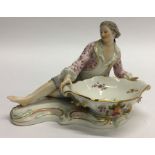 A Meissen figure of a gentleman decorated with flo