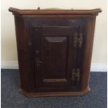 A small Georgian corner cupboard with panelled doo