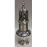 A massive George II silver caster with crested dec