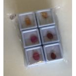 Six finely carved unmounted gemstones complete wit