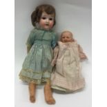 A porcelain headed doll together with one other. E