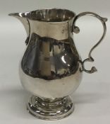 A Georgian sparrow beak silver cream jug of balust