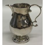 A Georgian sparrow beak silver cream jug of balust