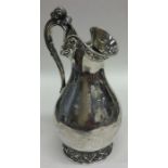 A Victorian silver ewer shaped cream jug decorated