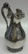 A Victorian silver ewer shaped cream jug decorated