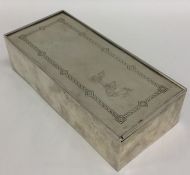 A rectangular silver music box with sliding top. A