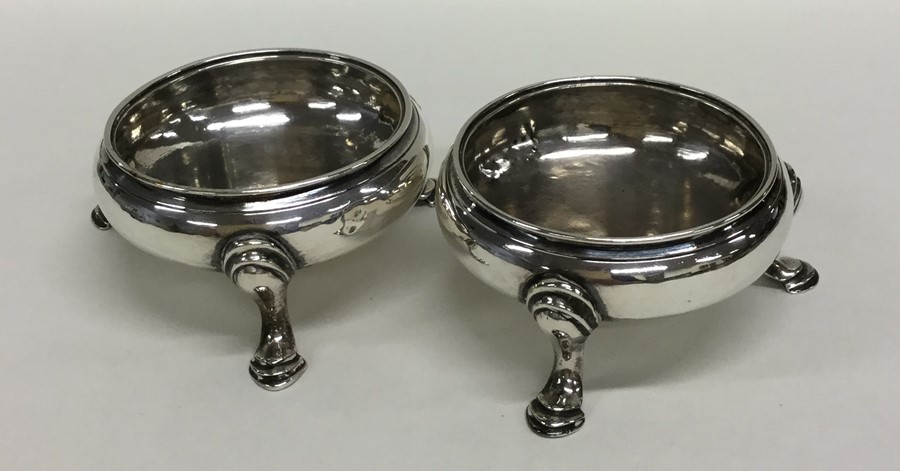 A pair of Georgian circular silver salts on reeded