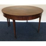 An Antique mahogany circular dining table on taper
