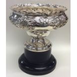 A large silver embossed rose bowl of stylish form