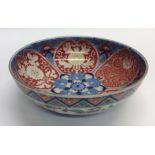 A Chinese shallow bowl decorated in blue, white an