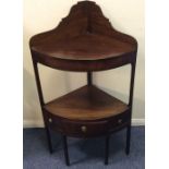 A Georgian mahogany corner wash stand on square su