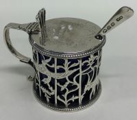 A large Georgian silver mustard decorated with flo