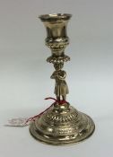 A Continental silver gilt tapering candlestick wit