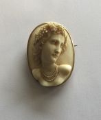 A large oval ivory cameo of a lady in high relief.