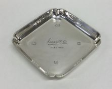 A heavy cast silver ashtray with engraved decorati