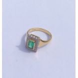 An emerald and diamond rectangular cluster ring in