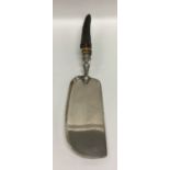 A silver crumb scoop with textured handle. Sheffie