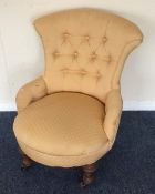 A small Edwardian button back armchair. Est. £25 -