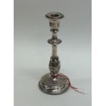 A good quality silver tapering candlestick decorated