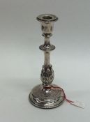 A good quality silver tapering candlestick decorated