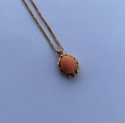 A heavy 18 carat coral pendant on fine link chain.