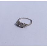 A diamond three stone ring in platinum claw mount.
