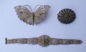 A silver filigree brooch together with matching br