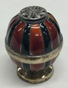 An unusual silver and enamel pepper with gilt inte