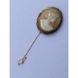 An oval cameo of a lady's head in gold frame. Appr