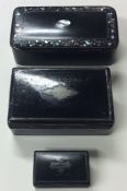 Three papier-mâché and silver inlaid snuff boxes. Es