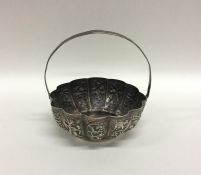 An Indian silver sugar basket decorated with figur