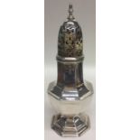 A tall Edwardian silver sugar caster with pierced