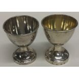 A pair of early Georgian silver egg cups of typica